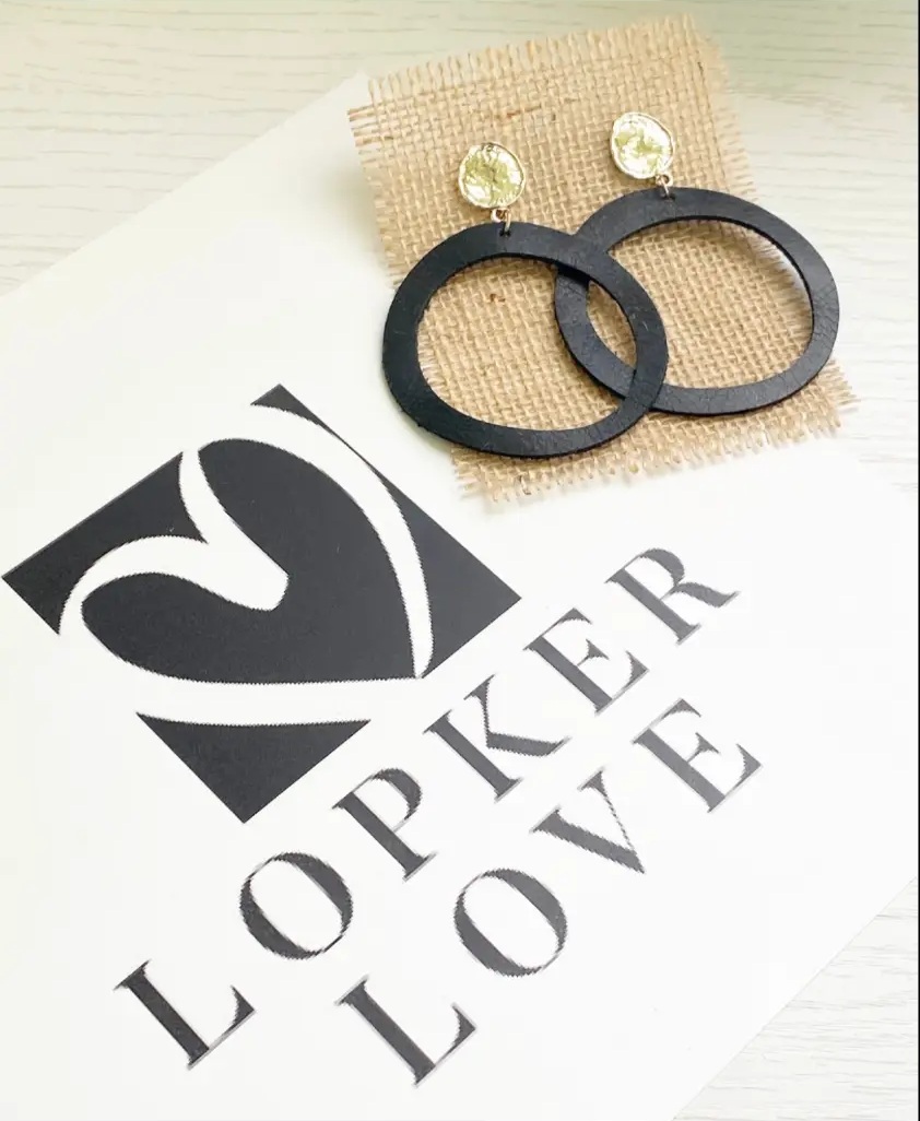 Black leather hoop earrings with gold studs on Lopker Love packaging